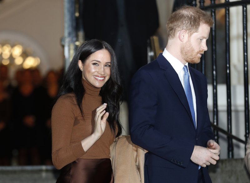 FILE - In this Jan. 7, 2020, file photo, Britain's Prince Harry and Meghan, Duchess of Sussex leave after visiting Canada House in London, after their recent stay in Canada. Prince Harry and Meghan Markle are to no longer use their HRH titles and will repay £2.4 million of taxpayer's money spent on renovating their Berkshire home, Buckingham Palace announced Saturday, Jan. 18. 2020. (AP Photo/Frank Augstein, File)
